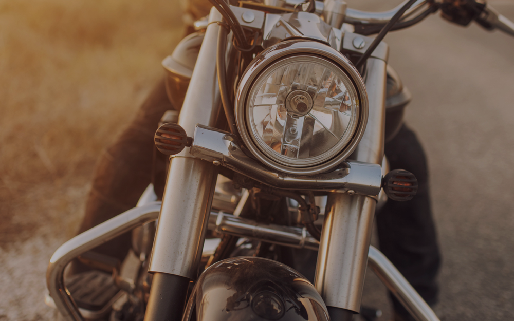 Close-up of a motorcycle headlamp and front forks