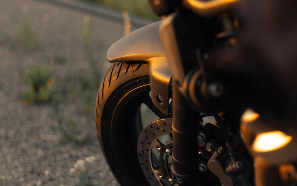 Close-up of a motorcycle's front wheel and suspension system